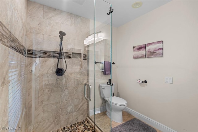 bathroom with toilet and a shower with door