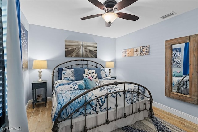 bedroom with ceiling fan and light wood-type flooring