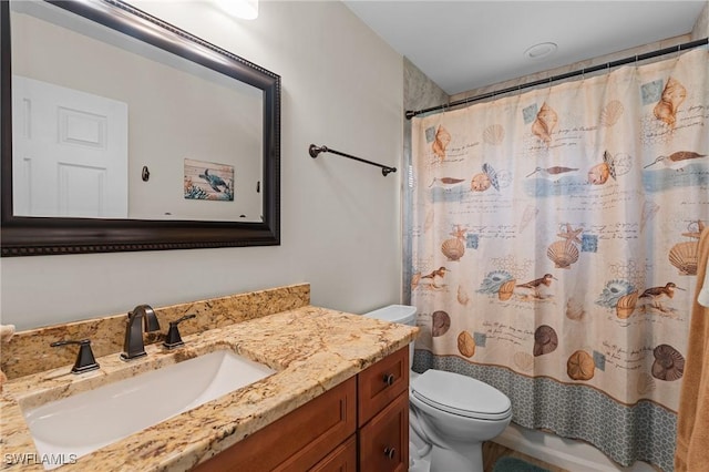 bathroom with vanity, toilet, and walk in shower