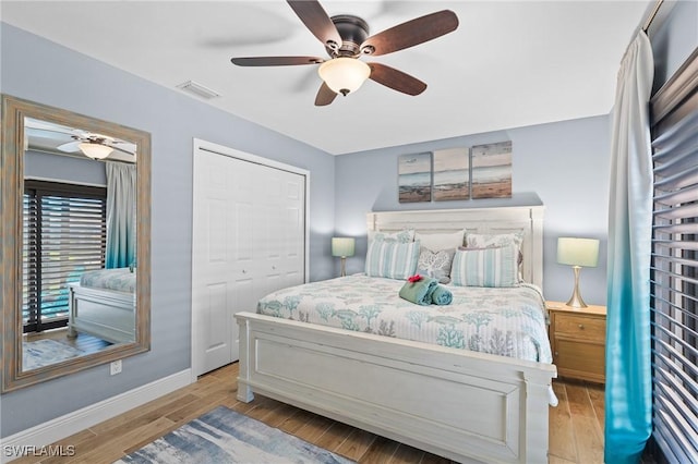 bedroom featuring ceiling fan, light wood-type flooring, and a closet