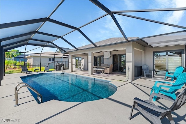 view of pool with ceiling fan, a lanai, and a patio