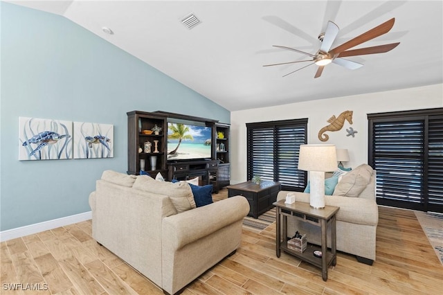 living room featuring ceiling fan and lofted ceiling