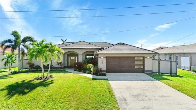 view of front of property with a front yard and a garage