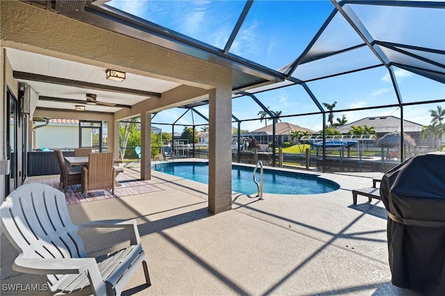 view of swimming pool featuring a lanai, ceiling fan, and a patio area