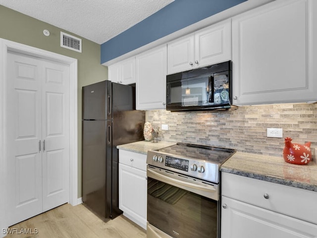 kitchen featuring tasteful backsplash, a textured ceiling, black appliances, and white cabinets