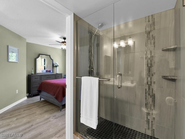 bathroom featuring a shower with door, hardwood / wood-style floors, a textured ceiling, and ceiling fan