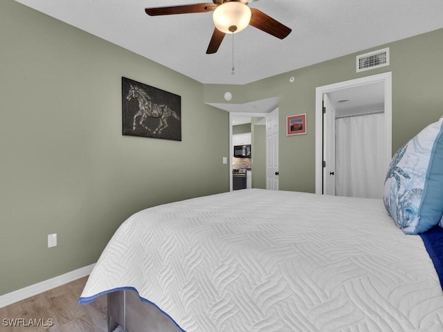 bedroom with ceiling fan and hardwood / wood-style floors