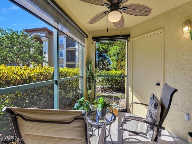 sunroom / solarium featuring ceiling fan