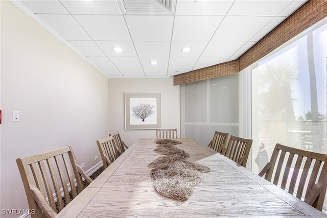 dining area featuring a paneled ceiling and crown molding