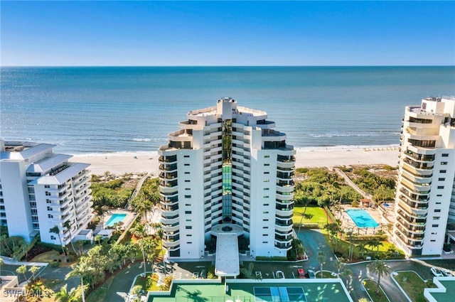 birds eye view of property with a water view and a view of the beach