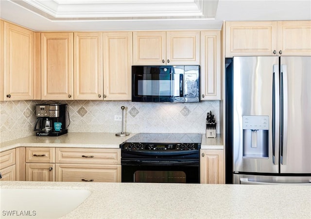 kitchen with decorative backsplash, light brown cabinetry, a tray ceiling, and black appliances