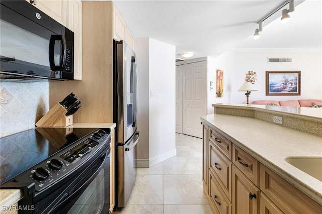 kitchen featuring black appliances, decorative backsplash, crown molding, and track lighting