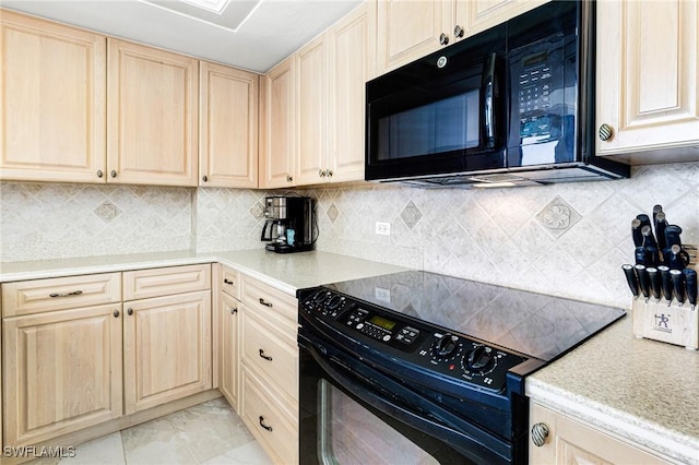 kitchen with light brown cabinetry, backsplash, and black appliances