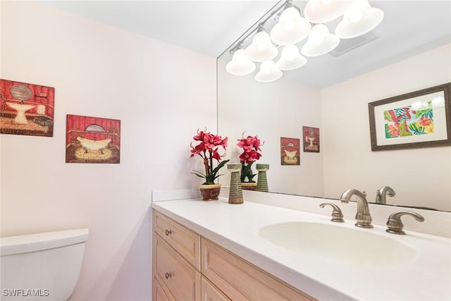 bathroom with vanity and toilet