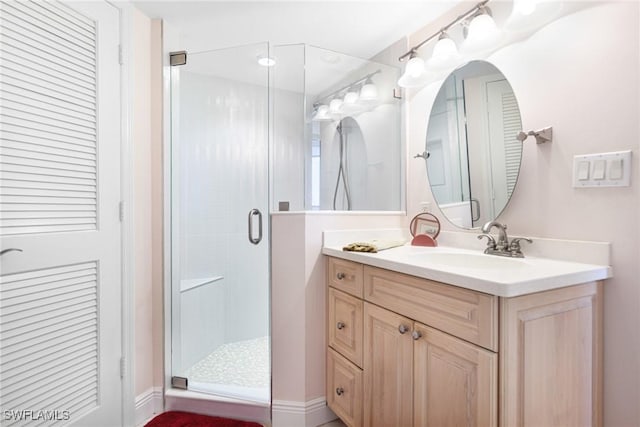 bathroom featuring vanity and an enclosed shower