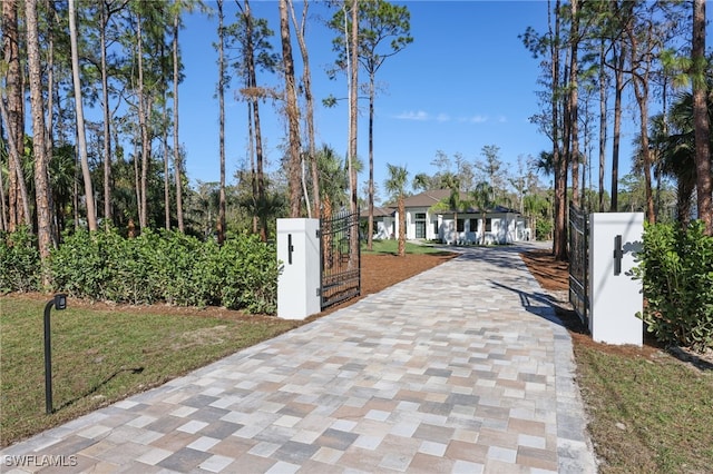 view of gate featuring a yard