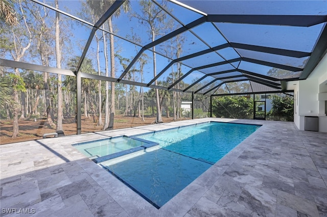 view of swimming pool featuring an in ground hot tub, a patio, and glass enclosure