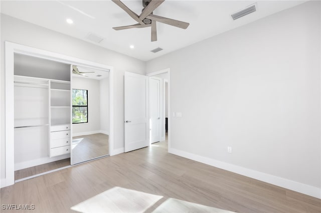 unfurnished bedroom featuring ceiling fan, light wood-type flooring, and a closet