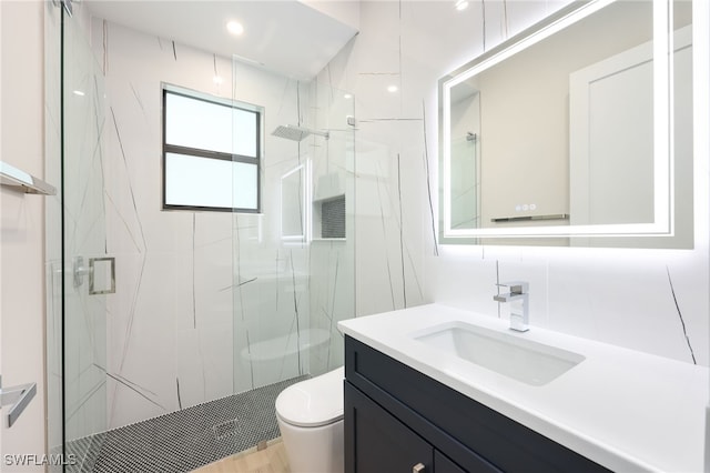 bathroom with vanity, toilet, and walk in shower