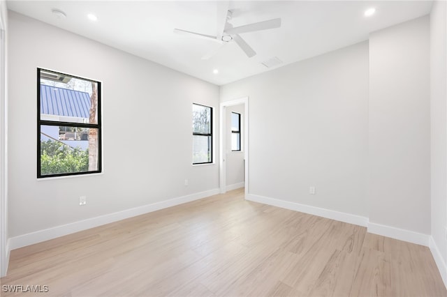 spare room featuring light wood-type flooring and ceiling fan