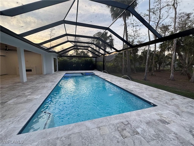 view of swimming pool with a patio area and a lanai