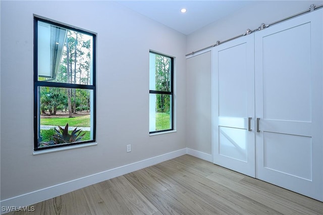 unfurnished room with a healthy amount of sunlight and light wood-type flooring