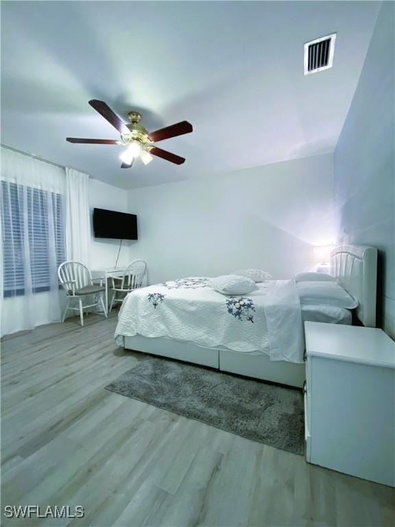 bedroom featuring visible vents, wood finished floors, and a ceiling fan