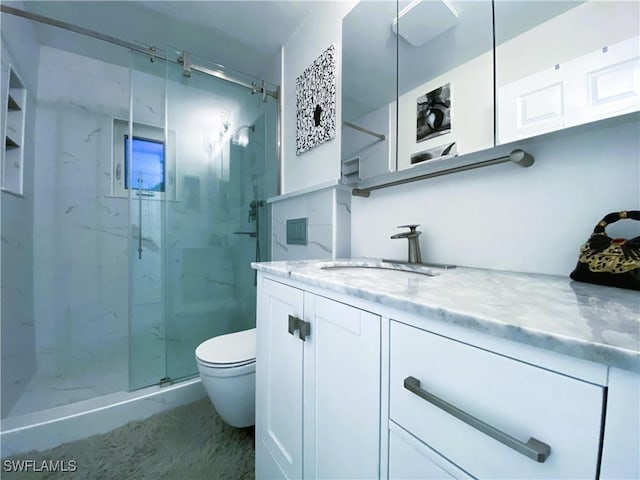 bathroom featuring a marble finish shower, toilet, and vanity