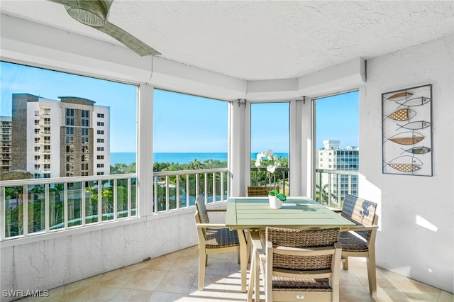 sunroom / solarium with plenty of natural light and a water view