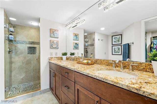 bathroom with vanity, tile patterned flooring, and a shower with shower door