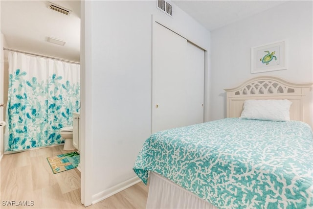 bedroom featuring light hardwood / wood-style floors and a closet