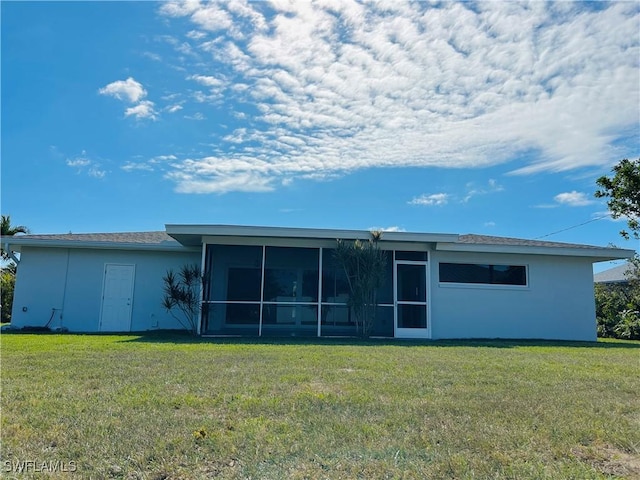 back of house featuring a sunroom and a yard