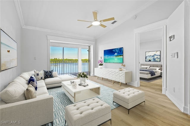 living room with ornamental molding, light wood-type flooring, ceiling fan, and lofted ceiling