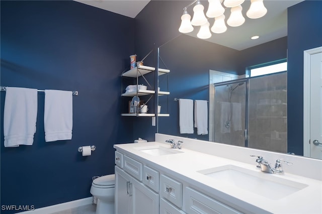 bathroom featuring vanity, toilet, and a shower with door