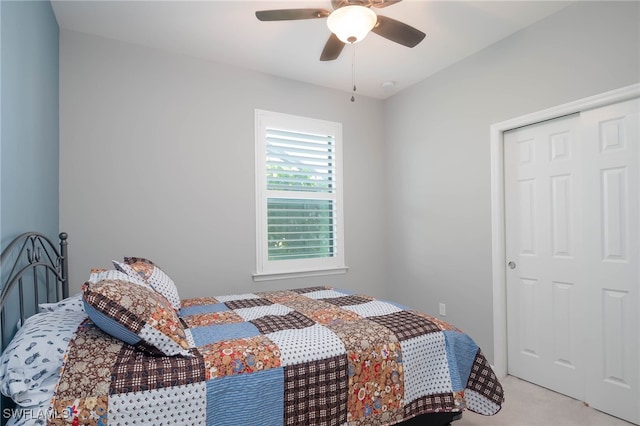 carpeted bedroom featuring ceiling fan and a closet