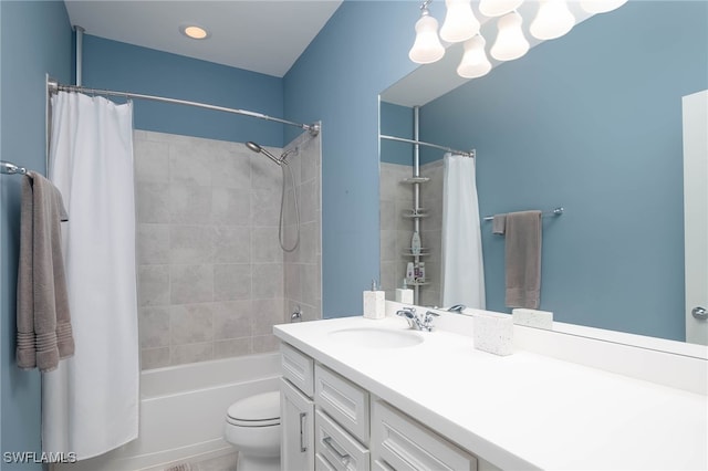 full bathroom featuring shower / tub combo with curtain, vanity, and toilet