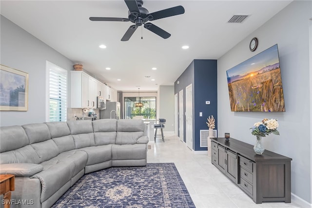 tiled living room with ceiling fan