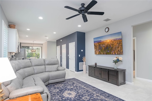 living room featuring ceiling fan and light tile patterned floors