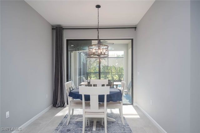 tiled dining room featuring a chandelier