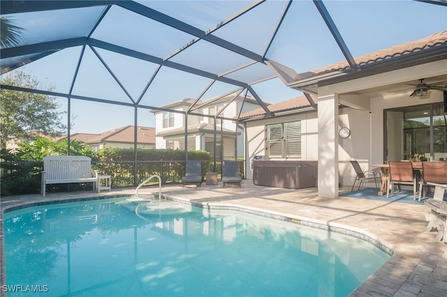 view of swimming pool featuring ceiling fan, a patio area, and glass enclosure