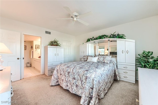 carpeted bedroom featuring ceiling fan and connected bathroom