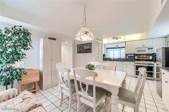 dining area featuring ceiling fan and light tile patterned floors