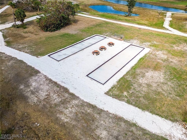 entry to storm shelter with a water view and a yard