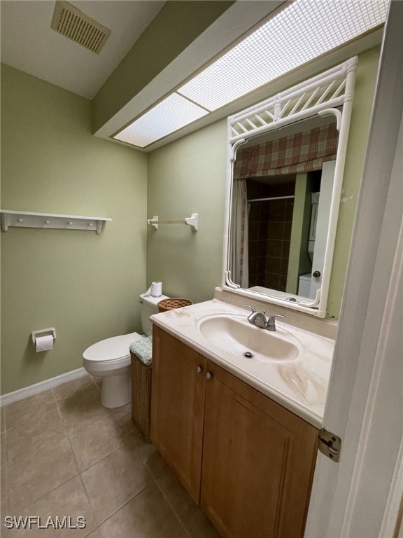 bathroom featuring a shower with shower curtain, tile patterned floors, vanity, and toilet