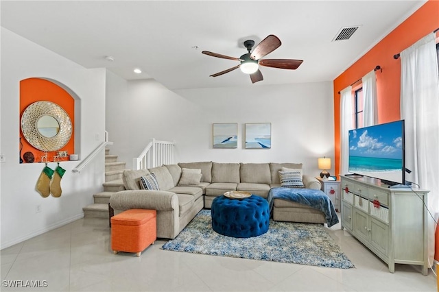 living room with light tile patterned floors and ceiling fan