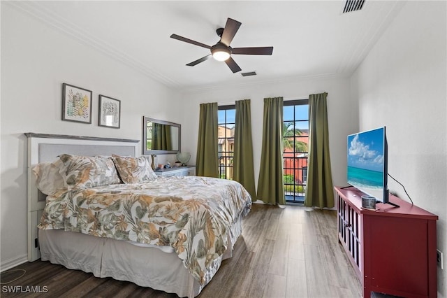 bedroom with hardwood / wood-style floors, ceiling fan, and ornamental molding