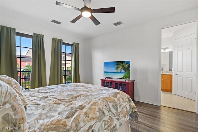 bedroom featuring crown molding, ceiling fan, dark hardwood / wood-style flooring, and ensuite bathroom