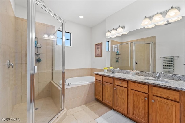 bathroom featuring separate shower and tub, tile patterned floors, and vanity