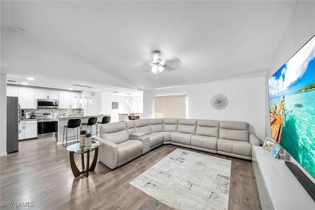 living room featuring ceiling fan and light wood-type flooring