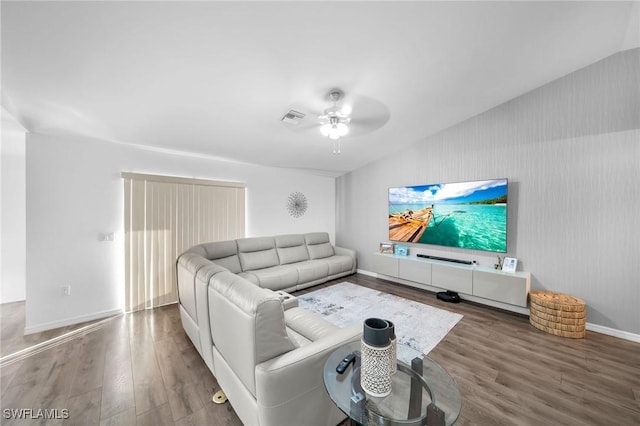 living room featuring hardwood / wood-style floors, ceiling fan, and lofted ceiling